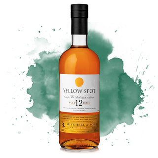 A bottle of Yellow Spot 12 Year Old Single Pot Still Irish Whiskey stands before a green watercolor background, its label displaying the age and brand name, suggesting flavors of milk chocolate and tropical fruit.