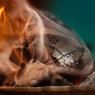 A close-up of Clase Azul Dia de Los Muertos 2024 Música Limited Edition Tequila 1L, with bright orange flames and swirling smoke, evokes toasted oak notes and highlights the heat and intensity of this exclusive release.