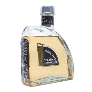 Aha Toro Artesanal Reposado Tequila 700ml features a curved, asymmetrical bottle with a dark label and light golden tequila crafted from agave, offering subtle oak and caramel notes.