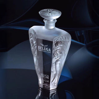 A frosted glass bottle of Beluga Epicure Vodka 700ml, featuring embossed female figures and a decorative stopper, stands out against a dark background, emphasizing its smooth taste and luxurious finish.