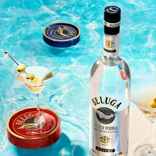 Beluga Noble Vodka bottle with a cocktail in a pool setting