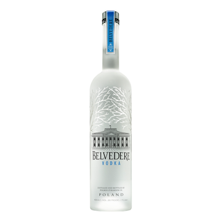 Belvedere Vodka 1.75L comes in a frosted glass bottle with silver tree branches, a blue neck label, and an image of a building. Made from rye grain in Poland, it features creamy notes and vanilla hints. The label reads "Belvedere Vodka.