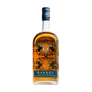 A 750ml bottle of Bluecoat Barrel Finish Gin features clear glass, amber liquid, blue and gold label accents, and a blue cap—highlighting the botanical depth and barrel-aged character of this premium gin.