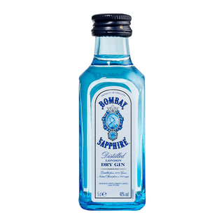 A 50mL blue glass bottle of Bombay Sapphire London Dry Gin with a white label, blue text, brand logo, botanical details, and a black screw cap.