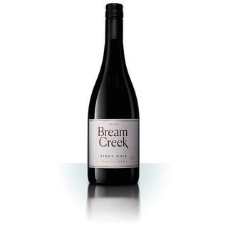 A bottle of Bream Creek Pinot Noir red wine from Tasmania, featuring a dark glass bottle with a white label and black cap, set against a clean white background with a soft reflection below.