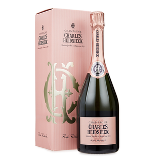 A bottle of Charles Heidsieck Rosé Réserve NV champagne stands before its matching pink and gold box, both elegantly branded—suggesting the refined bubbles and red fruit notes found inside.