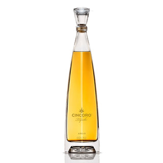 Cincoro Anejo Tequila 750ml is showcased in a tall, elegant glass bottle with golden amber liquid, gold label, and a sleek, modern design—hinting at caramelized agave and toasted oak flavors against a white background.