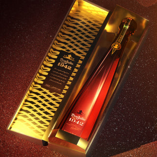 A bottle of Don Julio 1942 Añejo Tequila 750ml in a stylish gold-accented box, partially opened to reveal its tall, elegant design with gold and brown details—notes of honeyed agave stand out against the dark background.