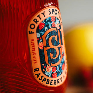 Close-up of a bottle label with 'Forty Spot' branding and raspberry flavor text.