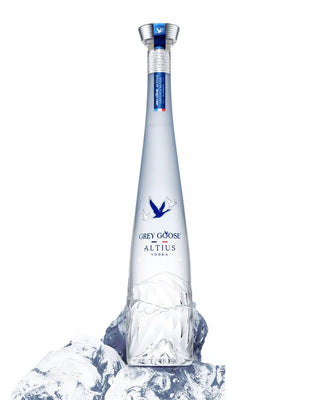 Grey Goose Altius vodka bottle with ice on a white background