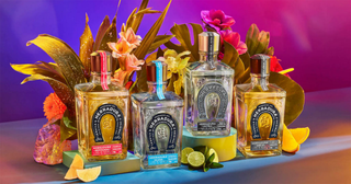 Herradura Reposado Tequila 700ml is showcased among vibrant flowers, tropical leaves, and fresh citrus slices against a colorful background, emphasizing its toasted oak and sweet agave notes in a festive atmosphere.