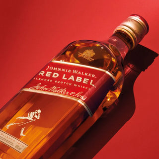 Johnnie Walker Red Label whisky bottle on a red background