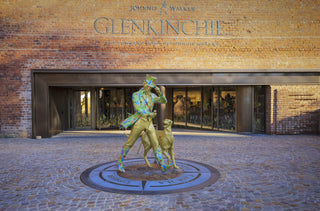 Statue of a man with a dog in front of Glenkinchie Distillery