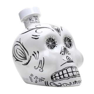 The KAH Tequila - Three Bottle Bundle features white, skull-shaped bottles with black sugar skull designs, including spider webs in the eyes and stylized teeth. Each bottle has a white cap labeled Tequila, hinting at the smooth agave spirit inside.