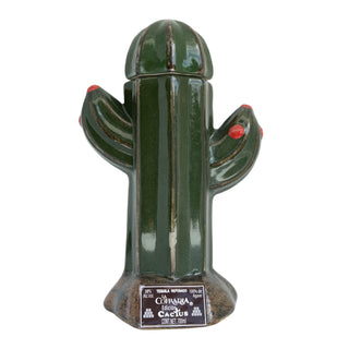 A green ceramic cactus-shaped bottle with red arm accents and removable top, labeled "La Cofradia Cactus Reposado 700ml," stands upright on a base. Inspired by agave.