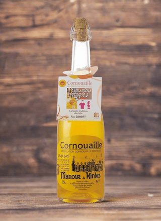 Bottle of Cornouaille liquor with a cork on a wooden surface and background