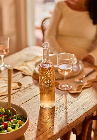 Bottle of sparkling wine on a wooden table with a blurred background