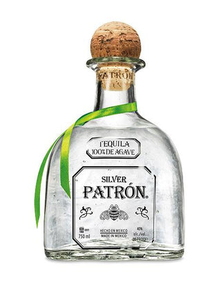 Patron Silver Tequila 700ml comes in a clear glass bottle with a wooden cork, accented by a green and yellow ribbon. Its label states "Tequila 100% de Agave," and it delivers smooth flavors with subtle citrus notes.