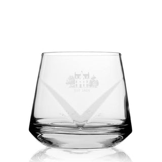 A clear glass rocks tumbler with a wide base and a subtle etched chateau design on the front, shown on a white background with a soft reflection below.