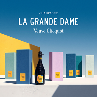 A bottle of Veuve Clicquot La Grande Dame 2015 (Lavanda) stands among vibrant textured boxes on a minimalist blue and yellow background, highlighting Pinot Noir and citrus zest notes, with “Champagne La Grande Dame Veuve Clicquot” above.
