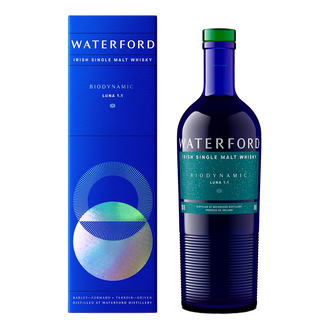 A blue bottle of Waterford Biodynamic Luna: Edition 1.1 Single Malt Whisky stands by its matching blue box, featuring white and teal label text that hints at notes of ripe orchard fruits and honeyed malt on a crisp white background.