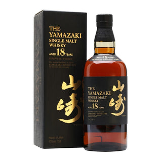 A bottle of The Yamazaki Single Malt Whisky aged 18 years next to its black packaging box with gold lettering, set against a plain white background.